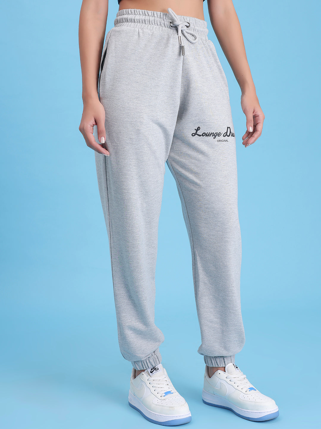 Lifestyle shot of grey joggers styled with a tee