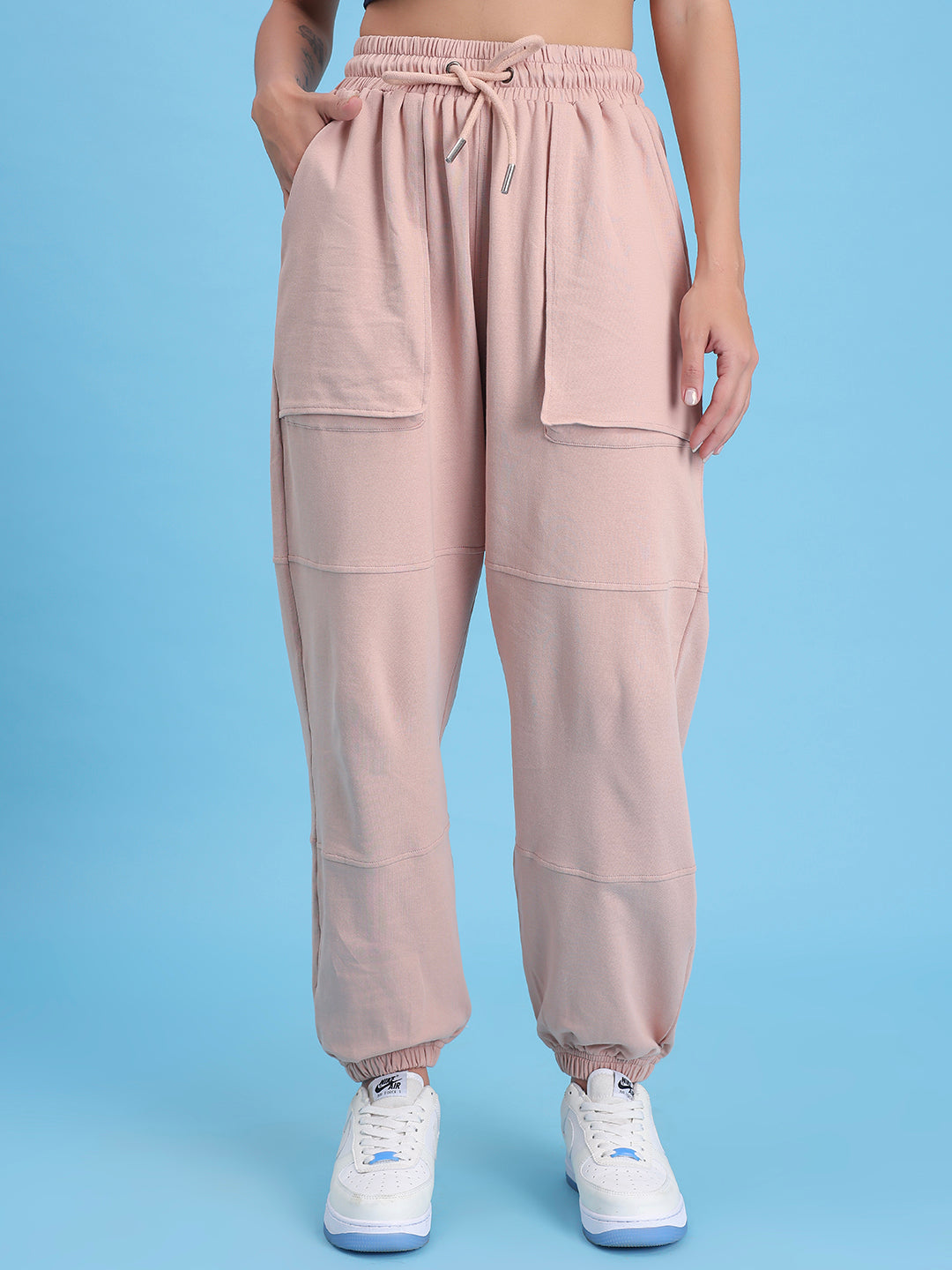 Front view of beige cotton knit joggers with tapered leg