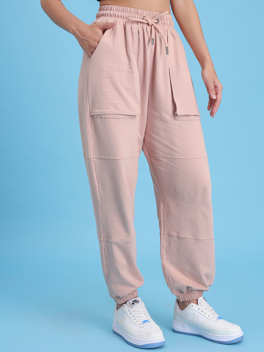 Lifestyle shot of beige joggers styled with a tee