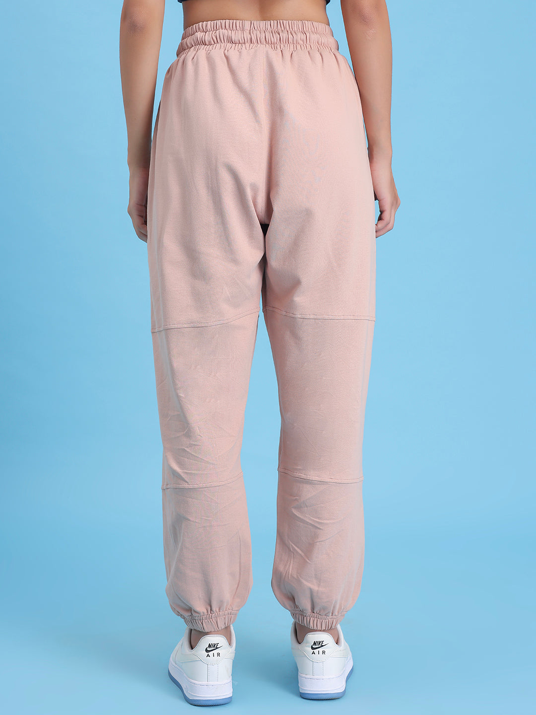 Detail of cuffed hem on beige cotton joggers