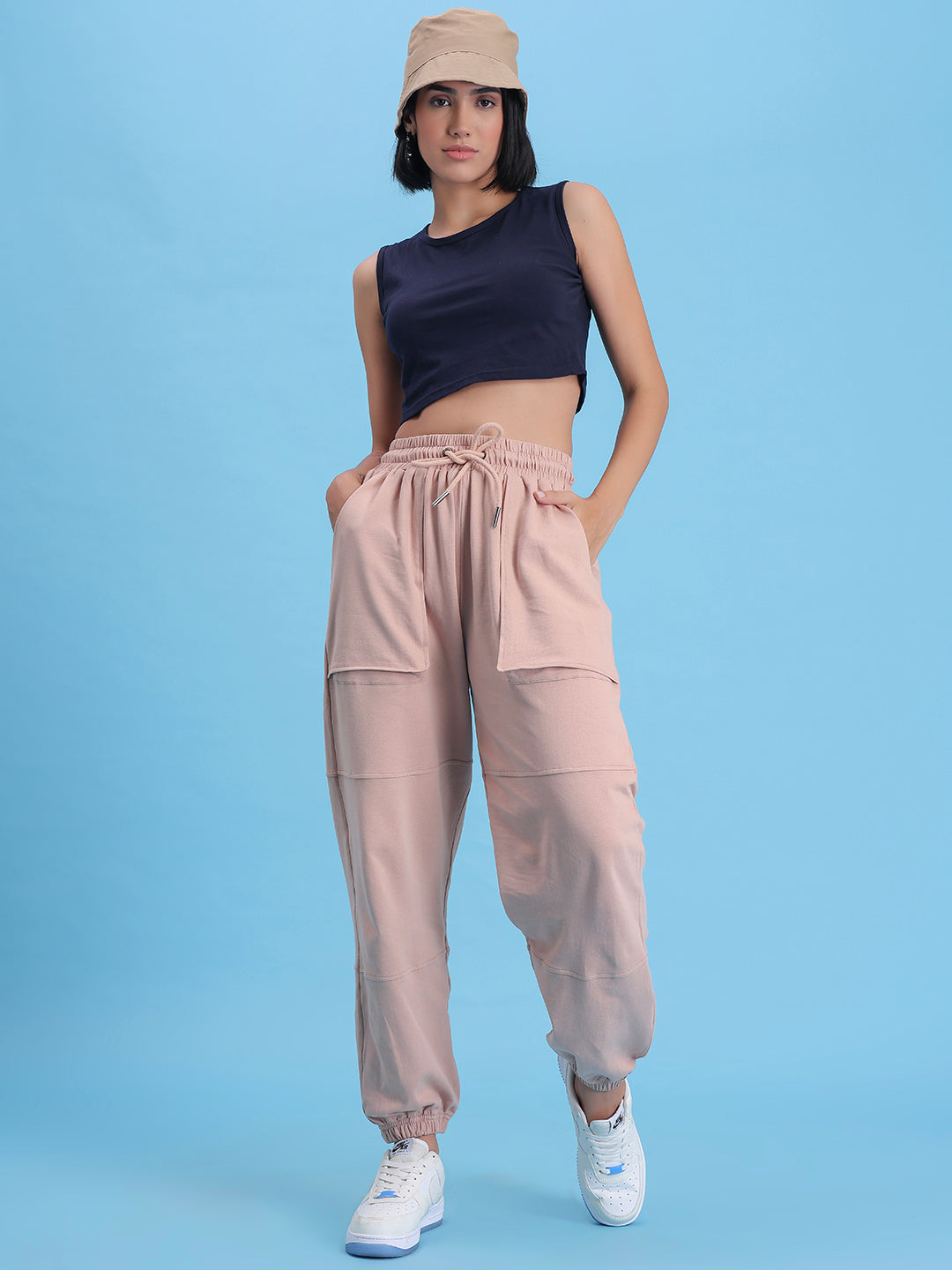 Model wearing beige cotton joggers in a casual look