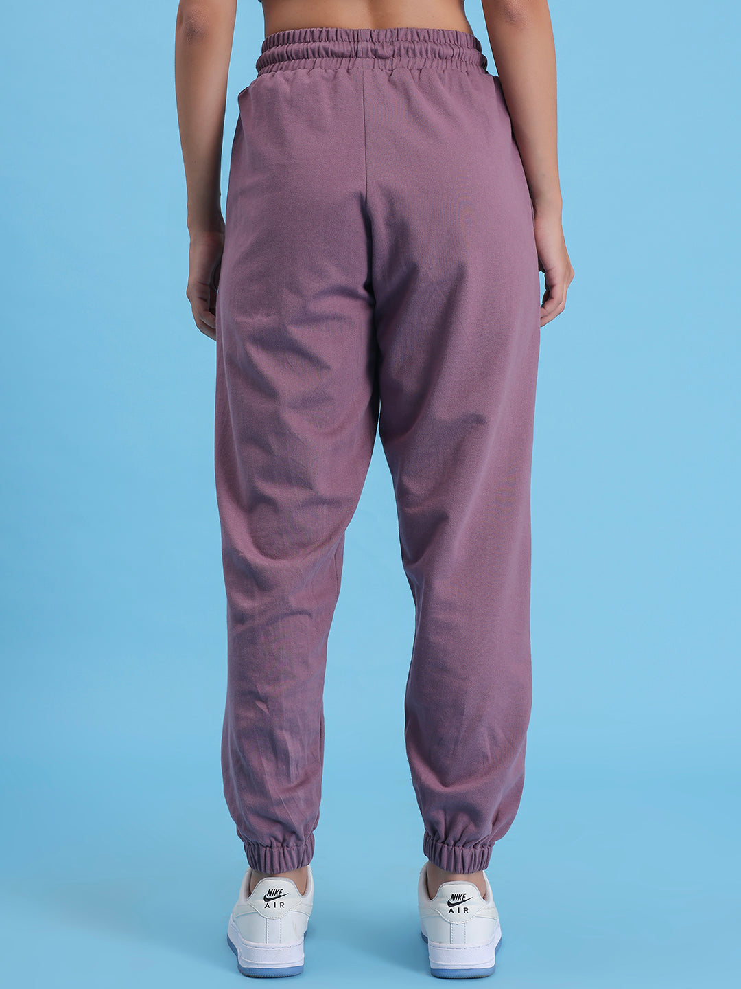 Close-up of elastic waistband on lavender knit joggers
