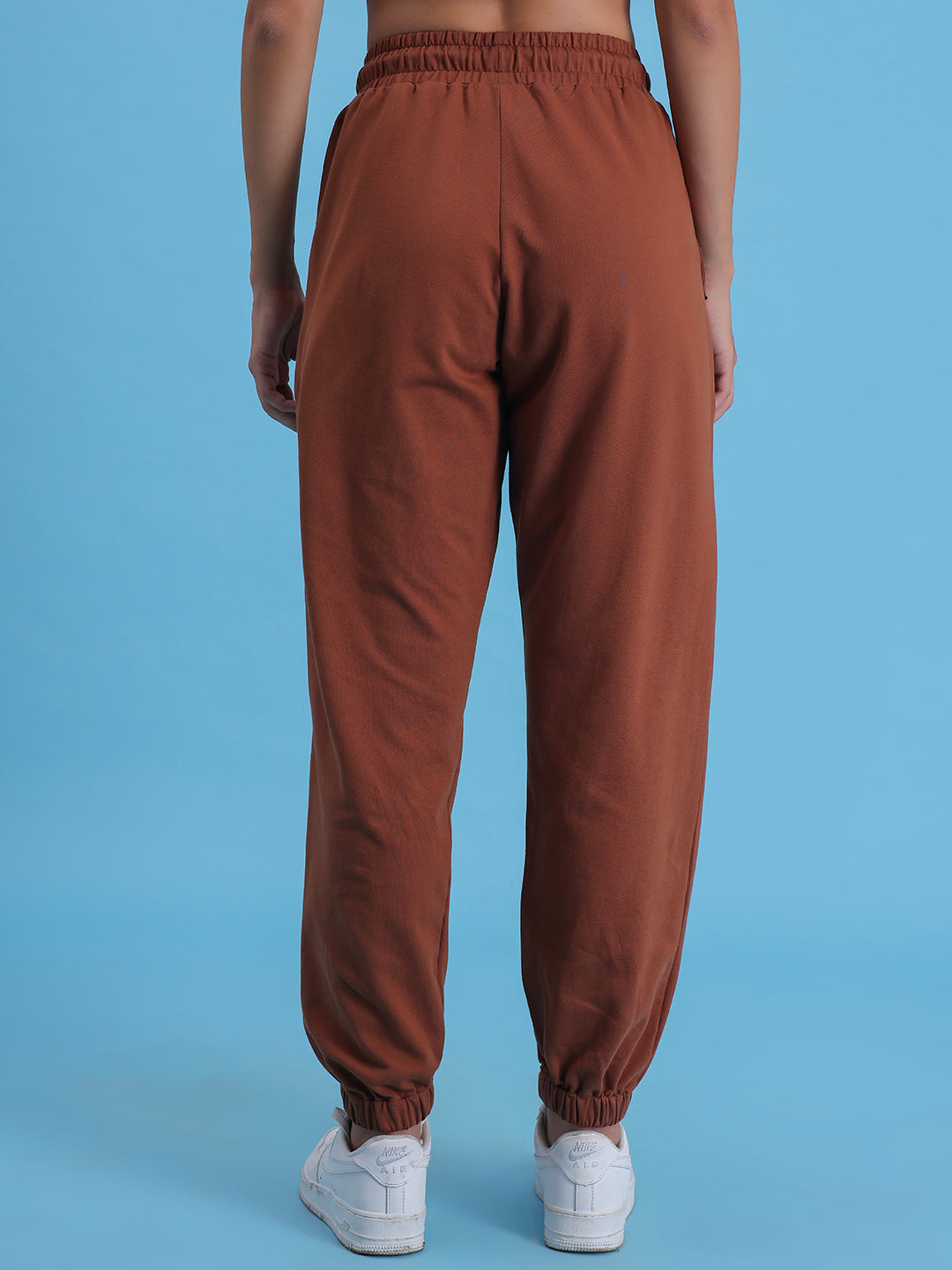 Close-up of elastic waistband on brown knit joggers