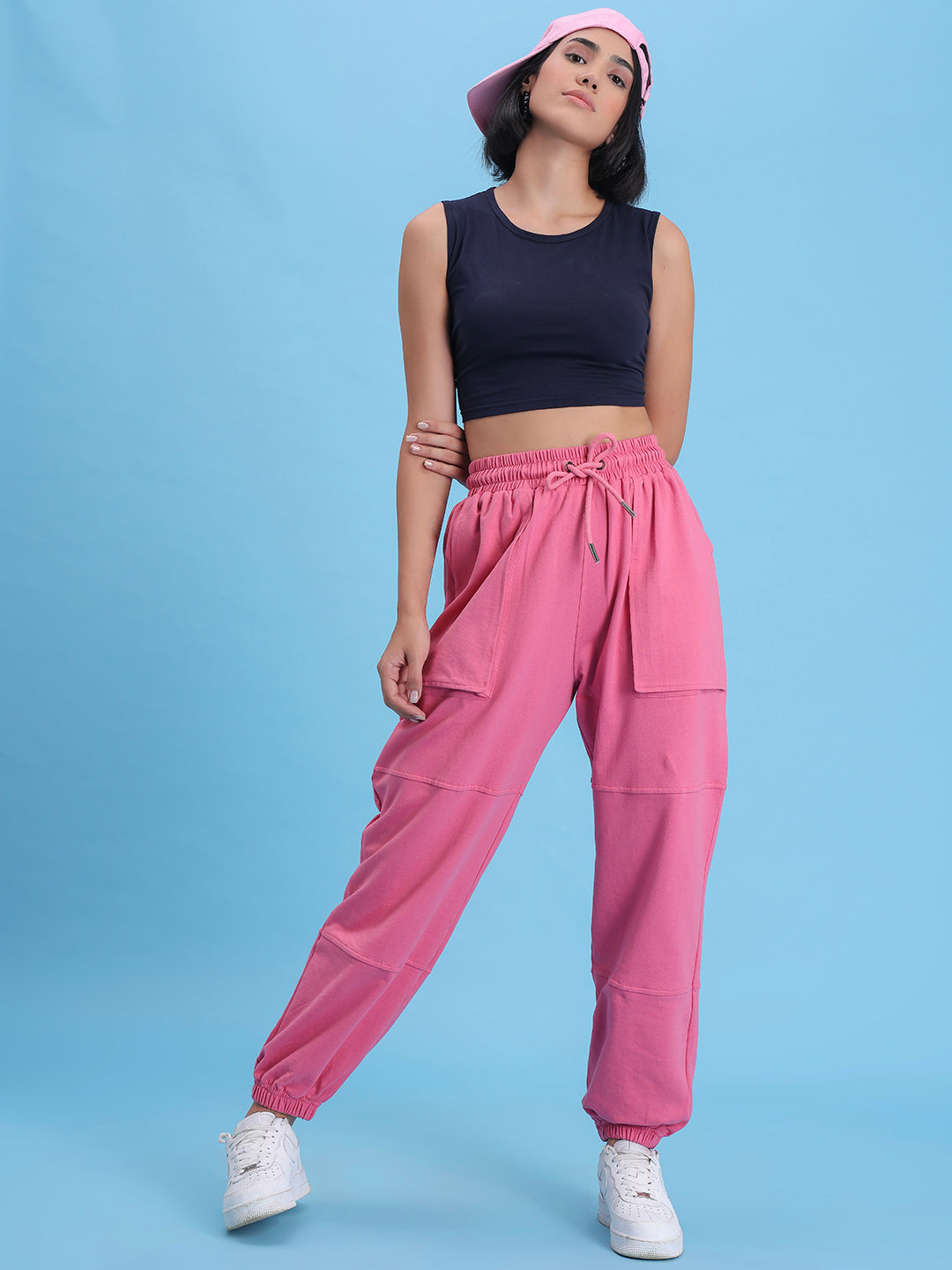 Lifestyle shot of pink joggers styled with a white tee
