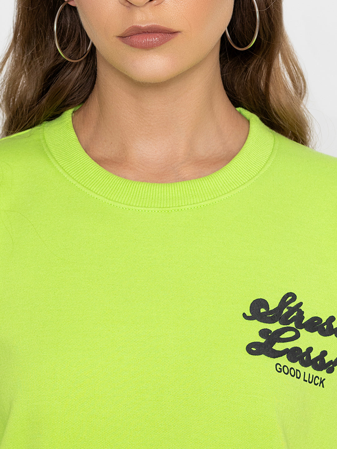 Neon green cotton sweatshirt shown in soft daylight