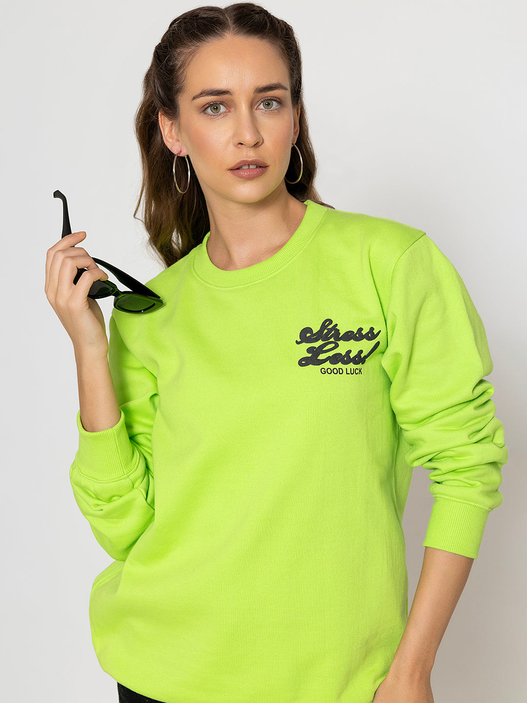 Detail of ribbed cuffs on neon green sweatshirt