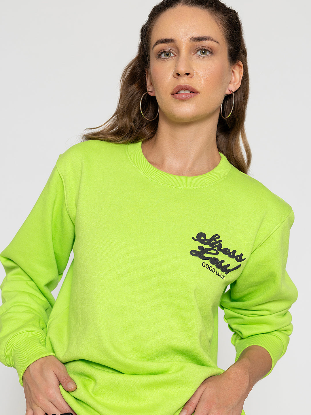 Lifestyle shot of neon green sweatshirt with joggers