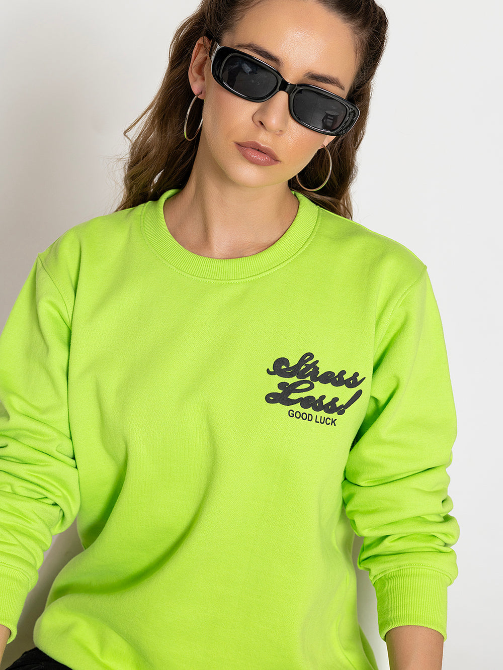 Side view of neon green sweatshirt showing relaxed fit
