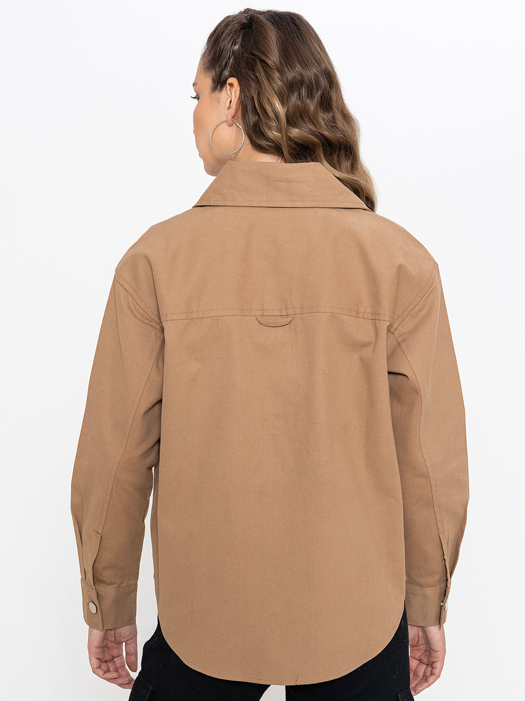 Detail of curved hem on beige cotton shacket