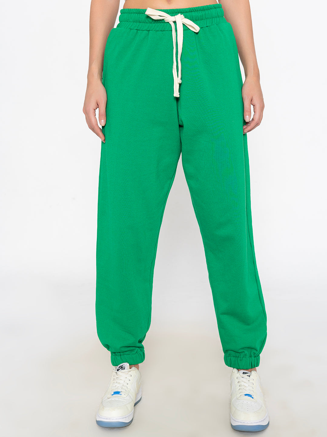 Front view of green cotton blend joggers for women with drawstring waist