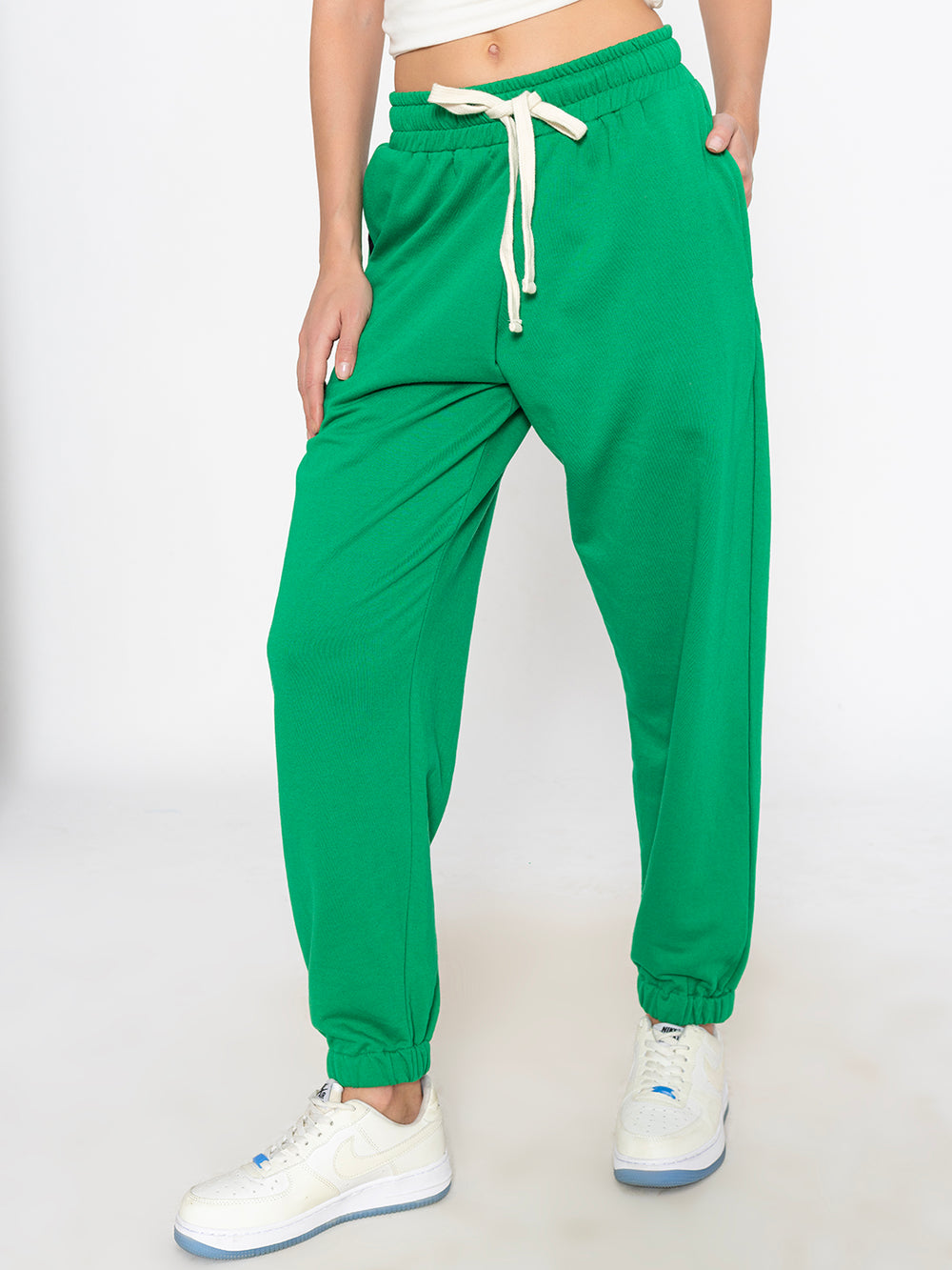 Side view of green cotton blend joggers showing tapered leg fit