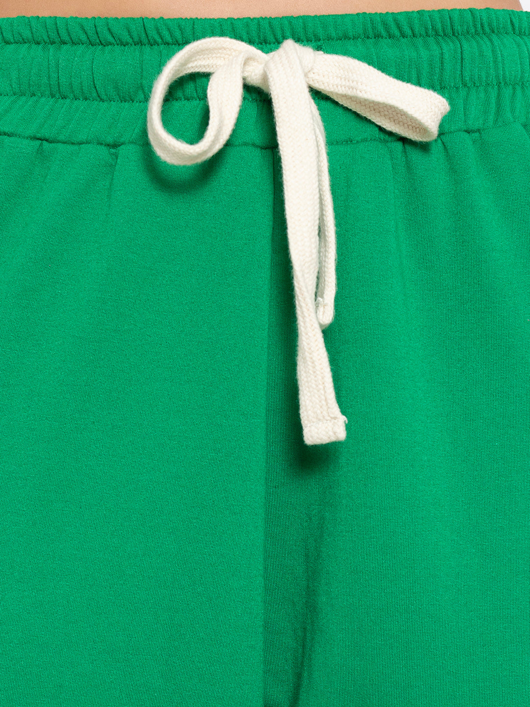 Full length view of green cotton blend joggers paired with white top