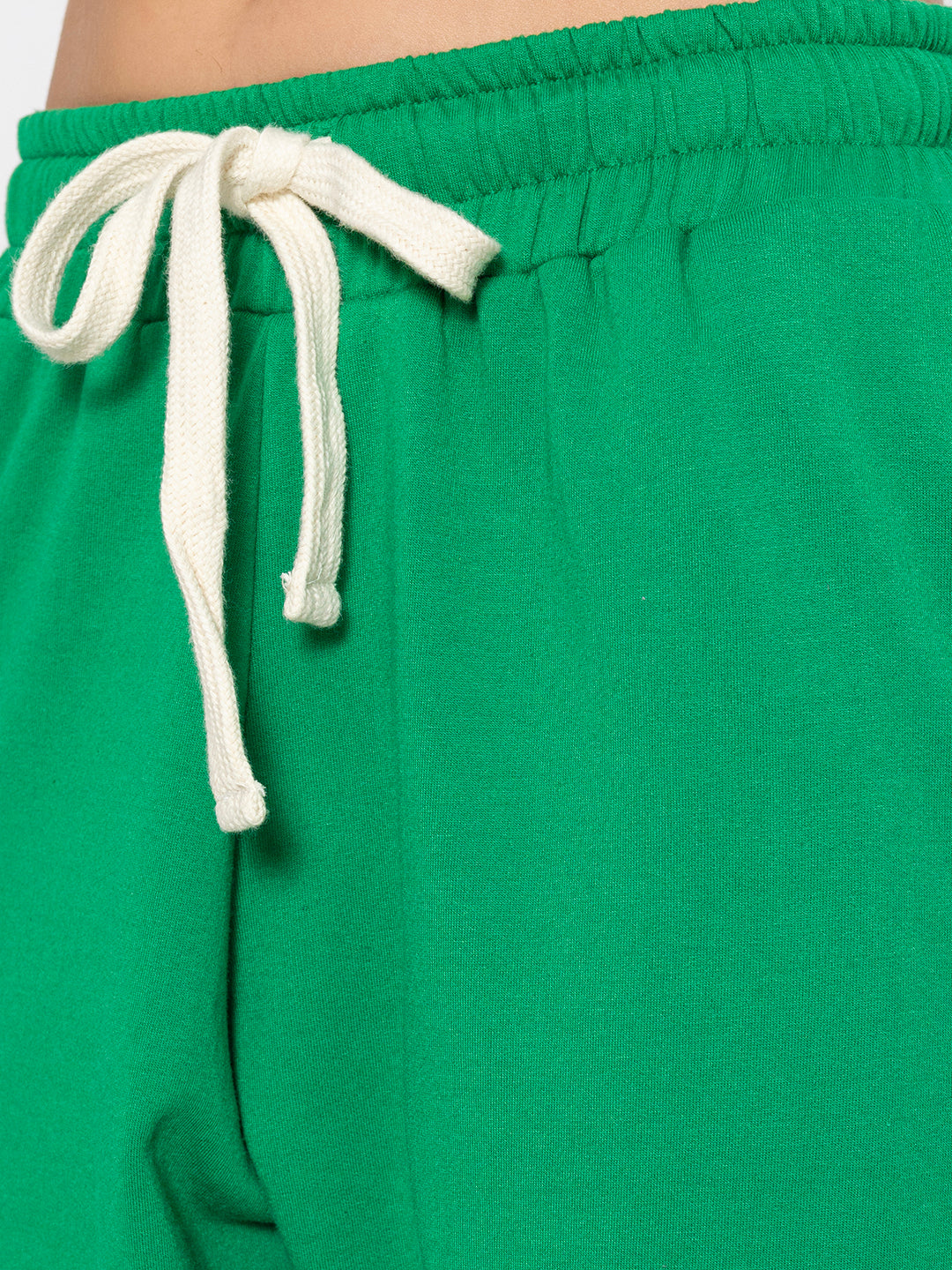 Detail shot of side pocket on green cotton blend joggers