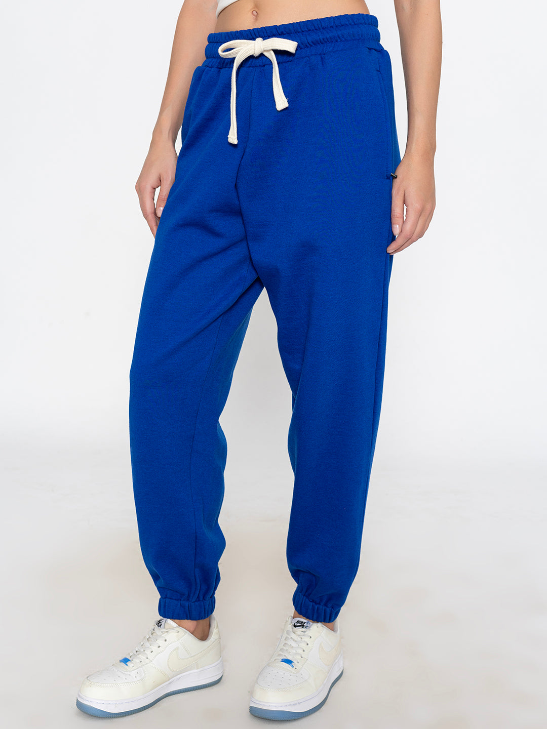 Side view of blue joggers showing tapered leg