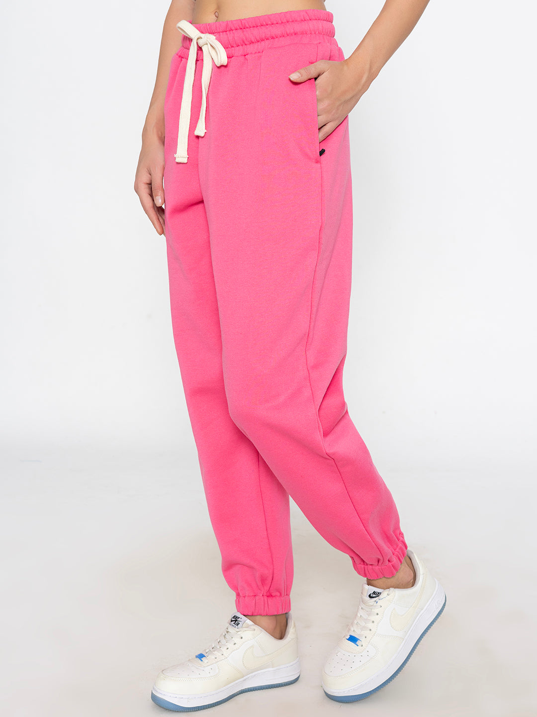 Detail of side pocket on pink cotton blend joggers