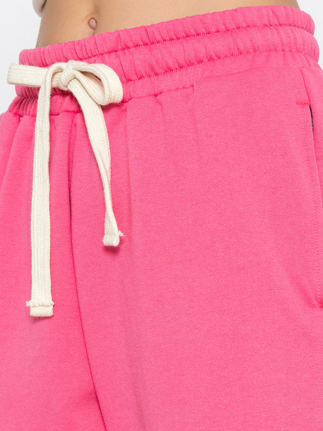 Pink joggers shown in soft natural daylight