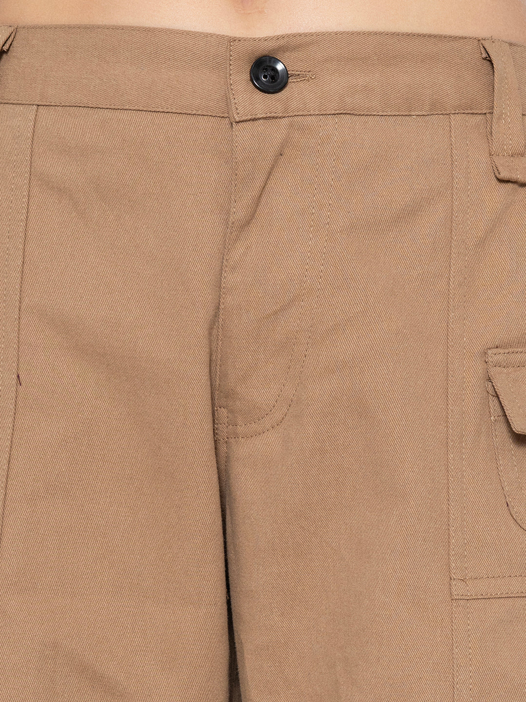 Full-length view of beige baggy trousers in cotton