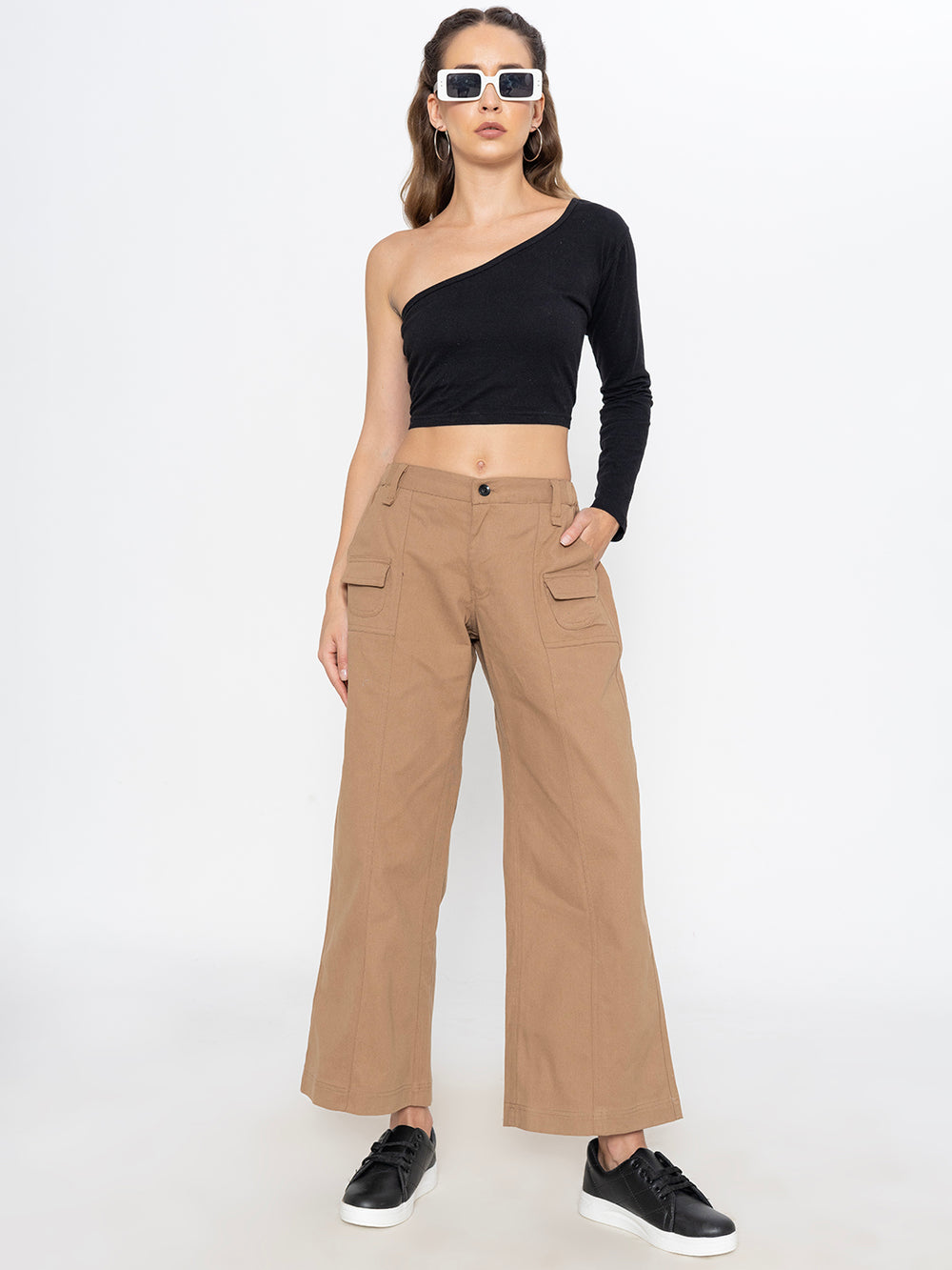 Side view of beige cotton baggy trousers showing tapered leg