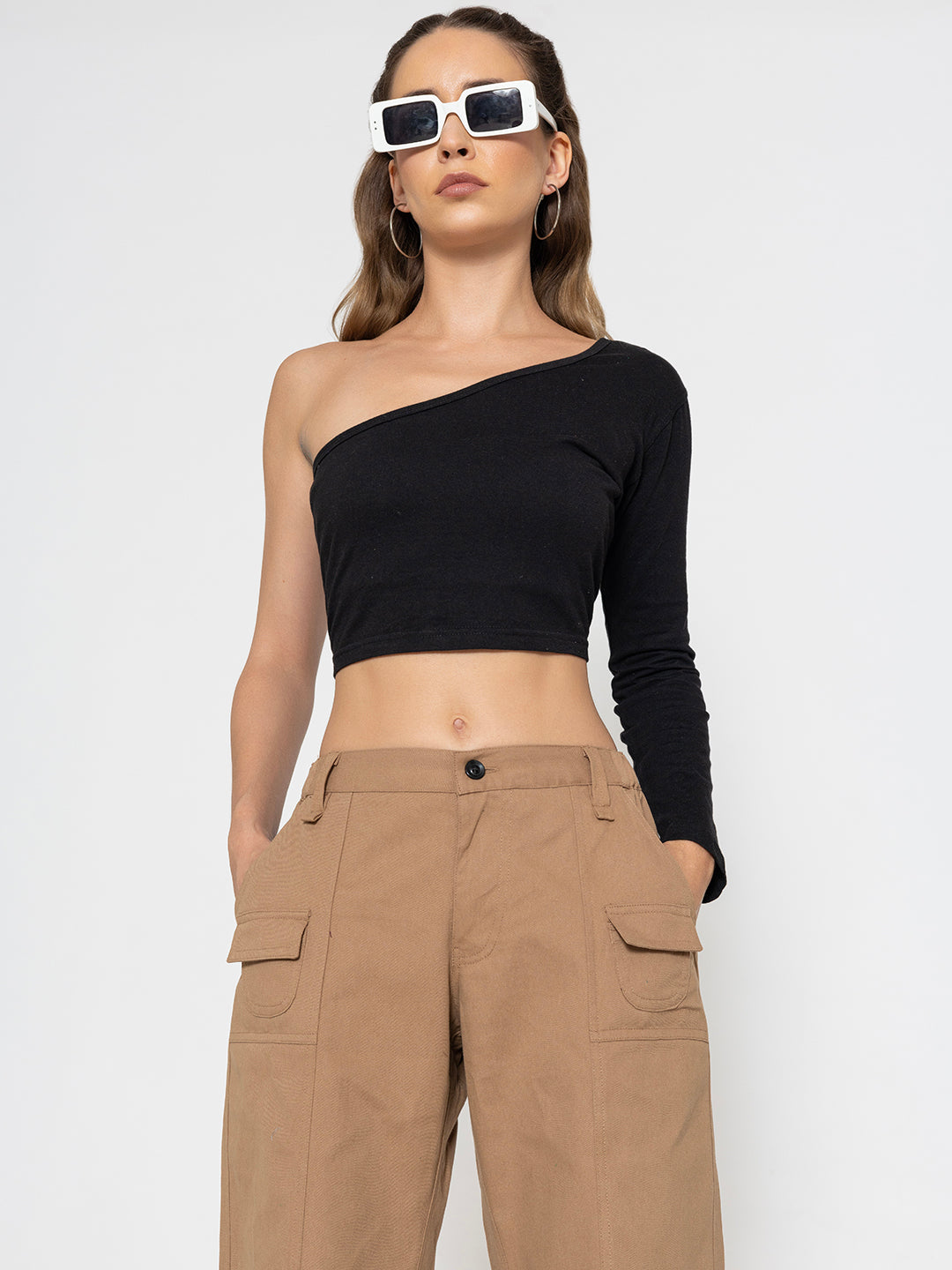 Detail of side pocket on beige baggy cotton trousers
