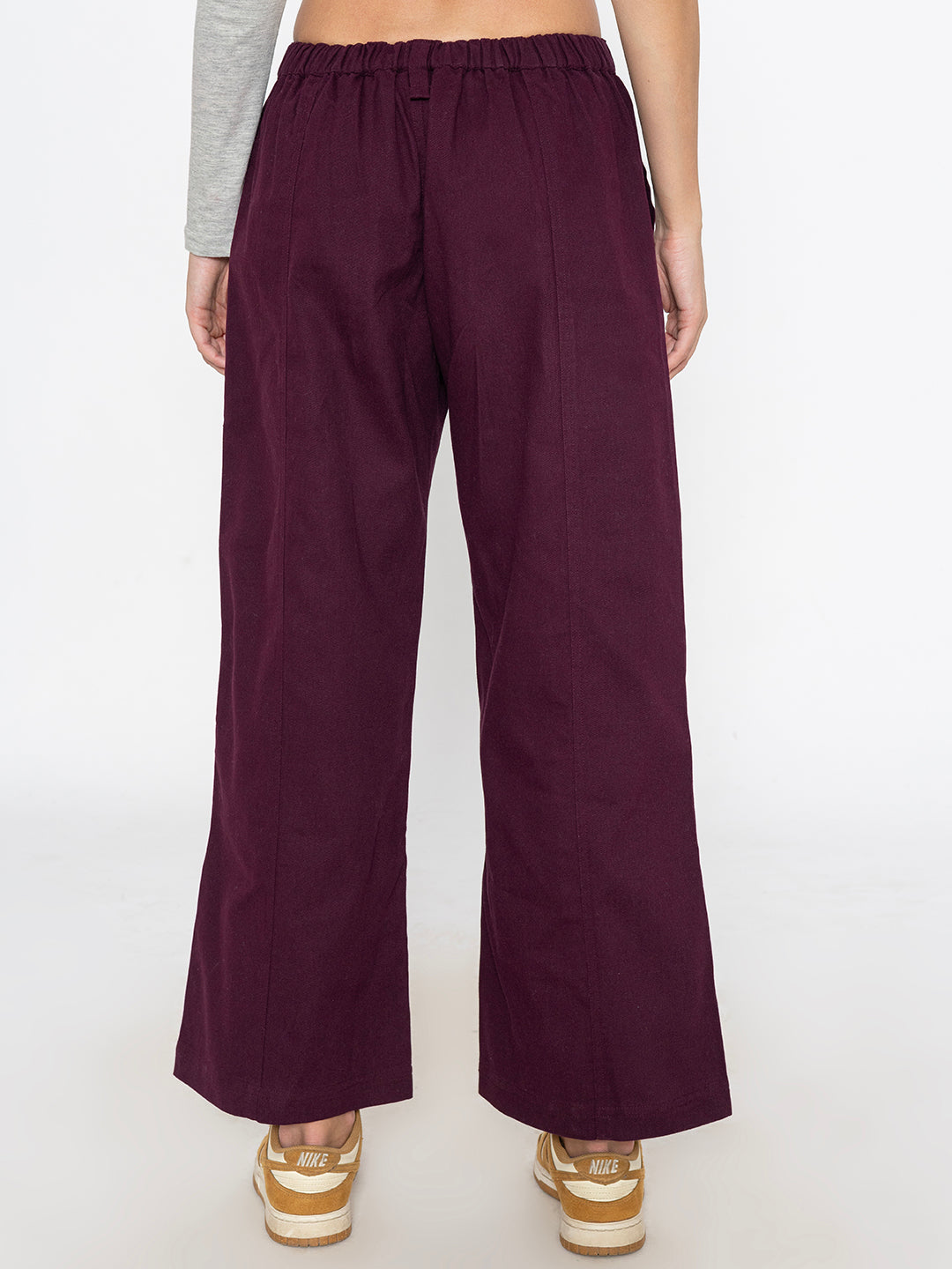 Wine cotton baggy trousers shown in soft daylight