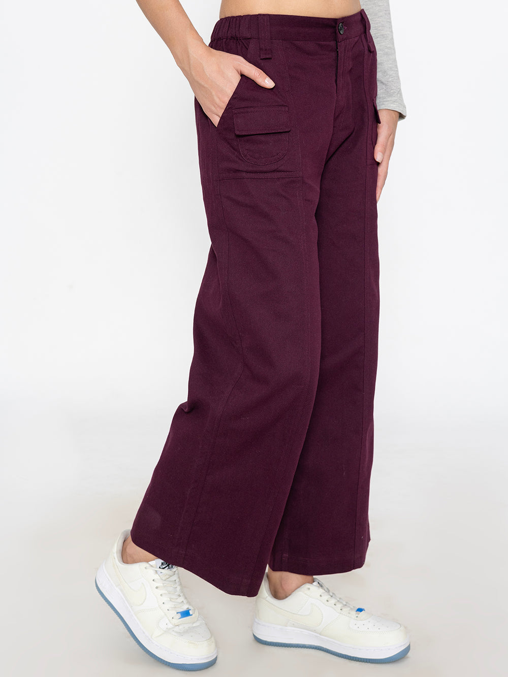 Side view of wine baggy trousers showing tapered leg