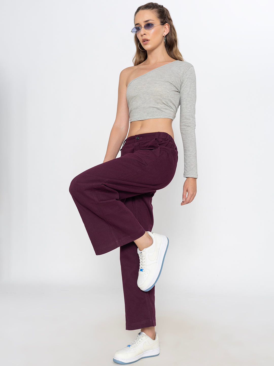 Detail of side pocket on wine baggy cotton trousers