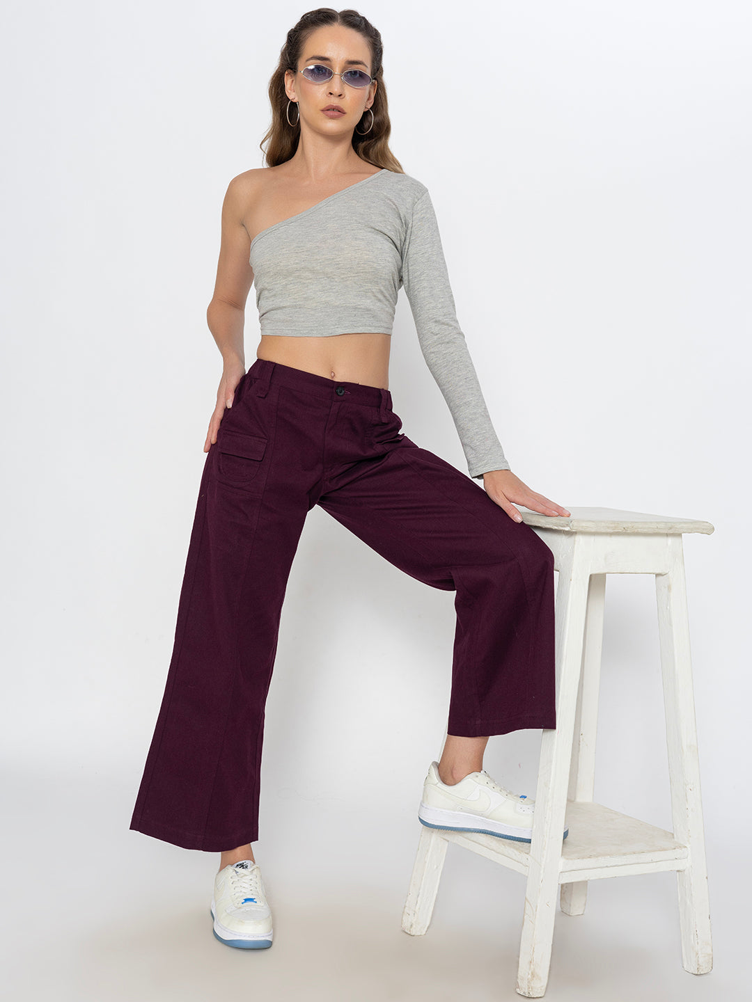 Lifestyle shot of wine cotton baggy trousers styled with tee