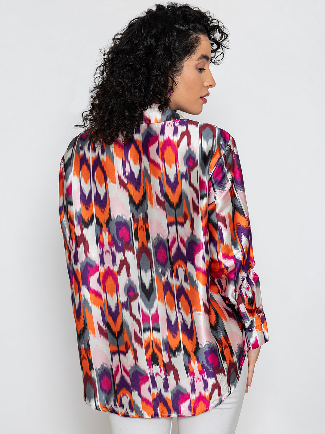 Lifestyle shot of multicolor Atik print satin shirt styled casually