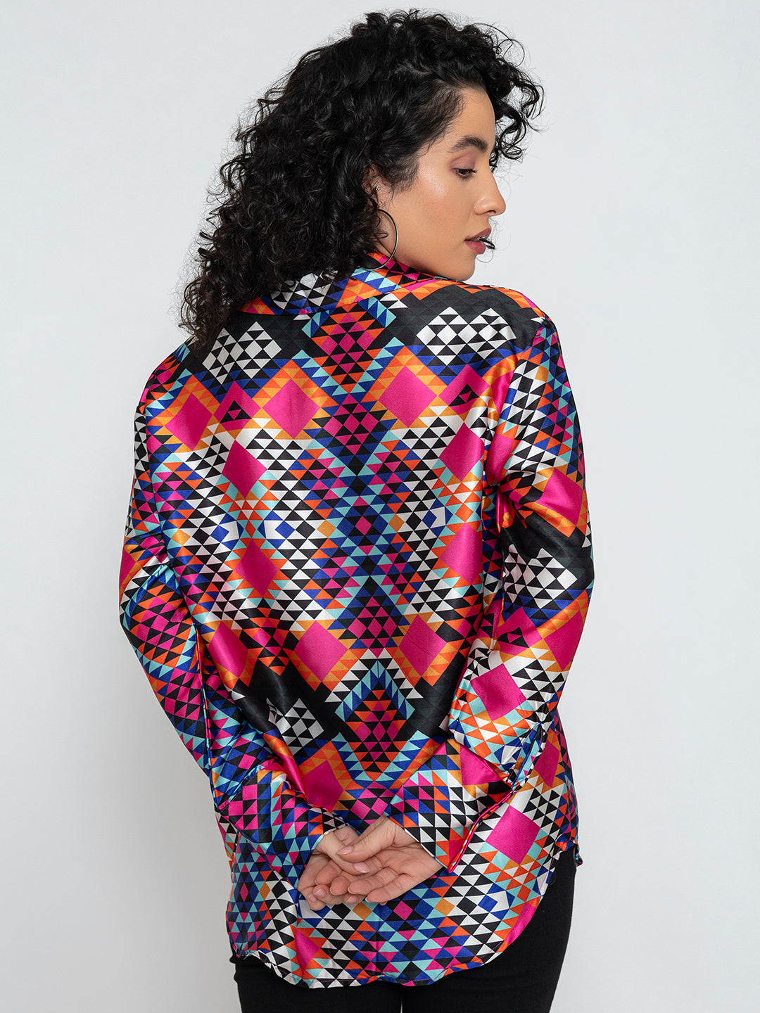 Lifestyle shot of multicolor floral satin shirt styled with denim