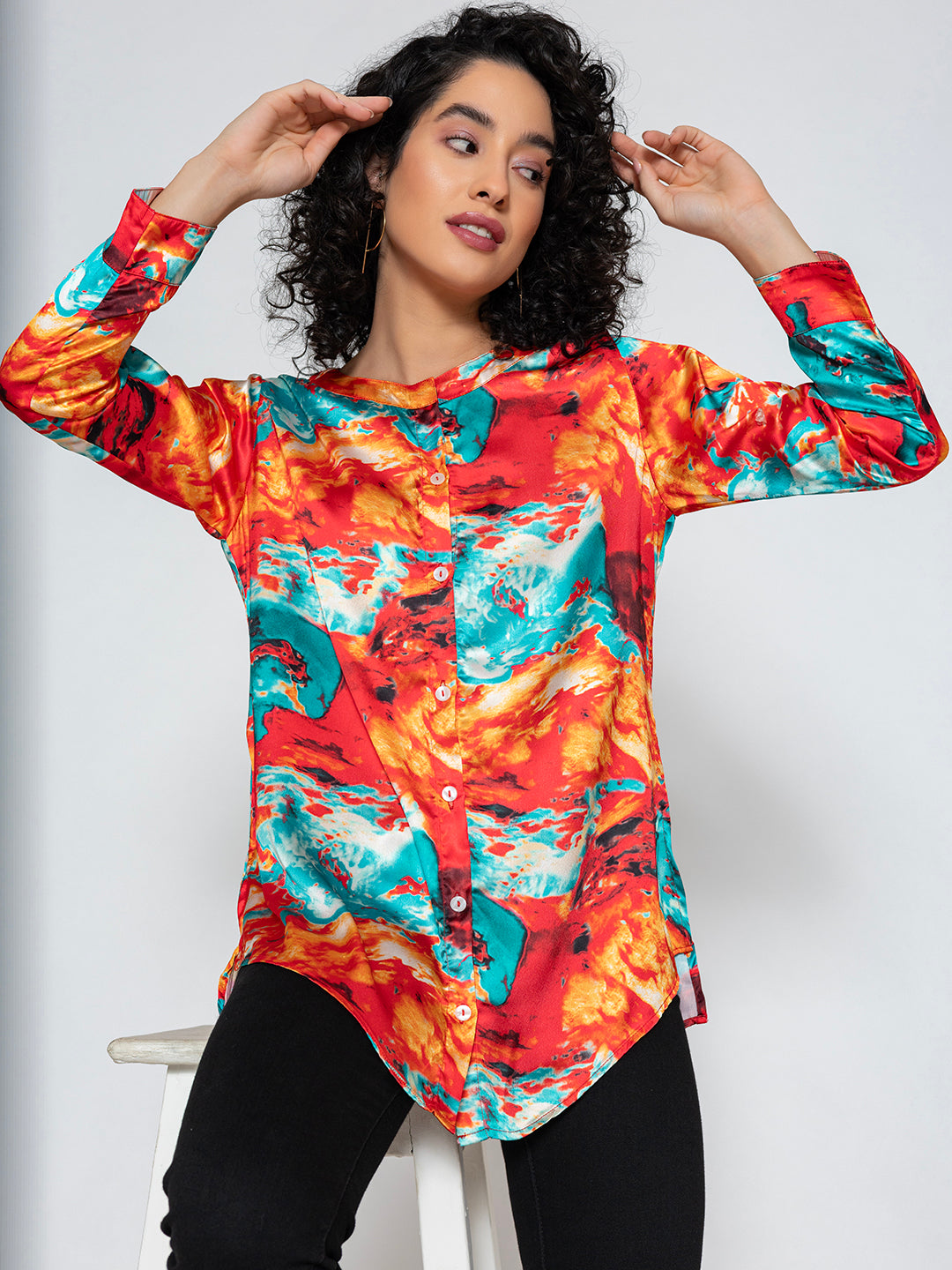 Close-up of floral print on red satin kurta fabric