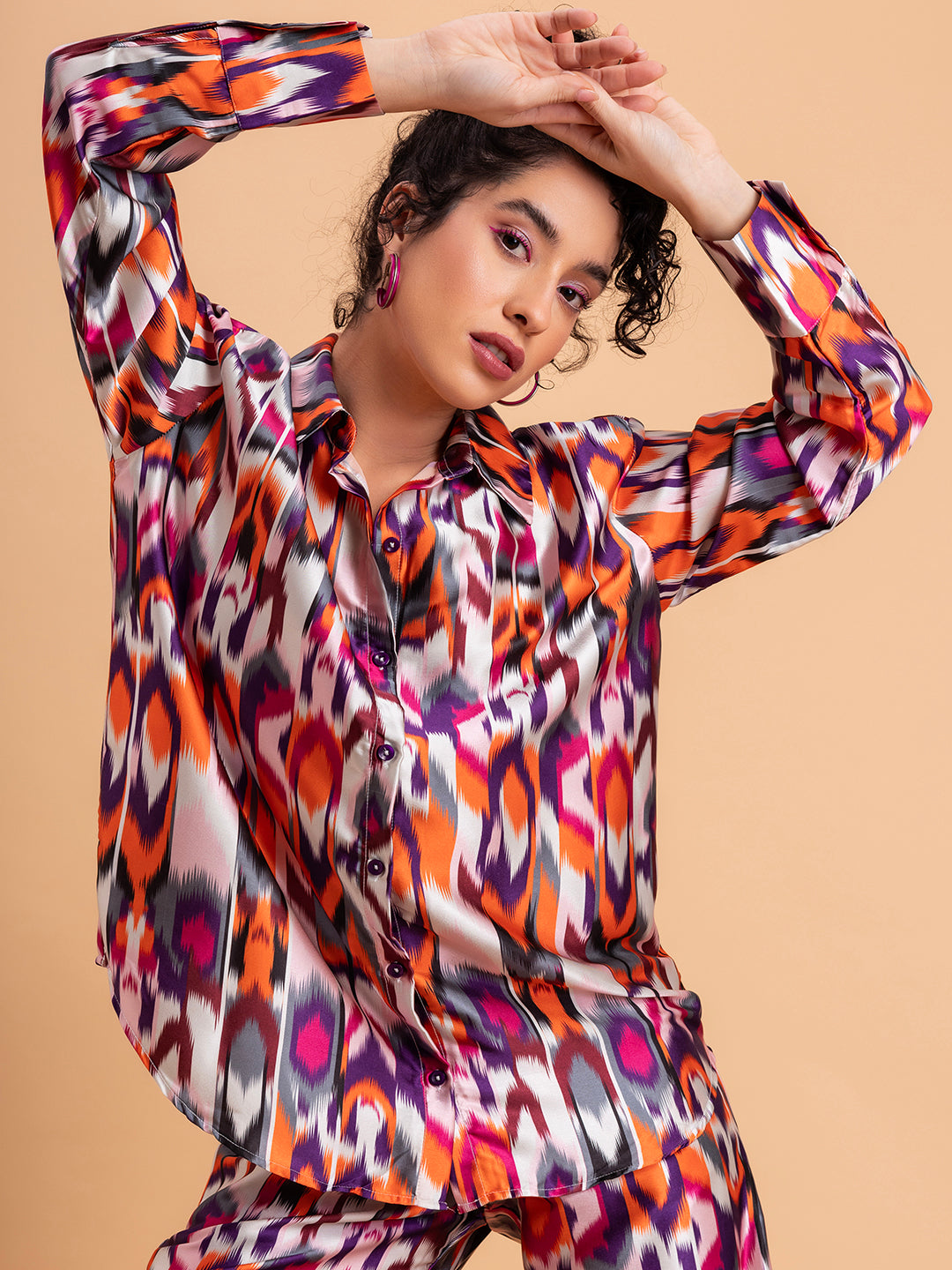 Lifestyle shot of multicolor Atik satin co-ord styled with heels