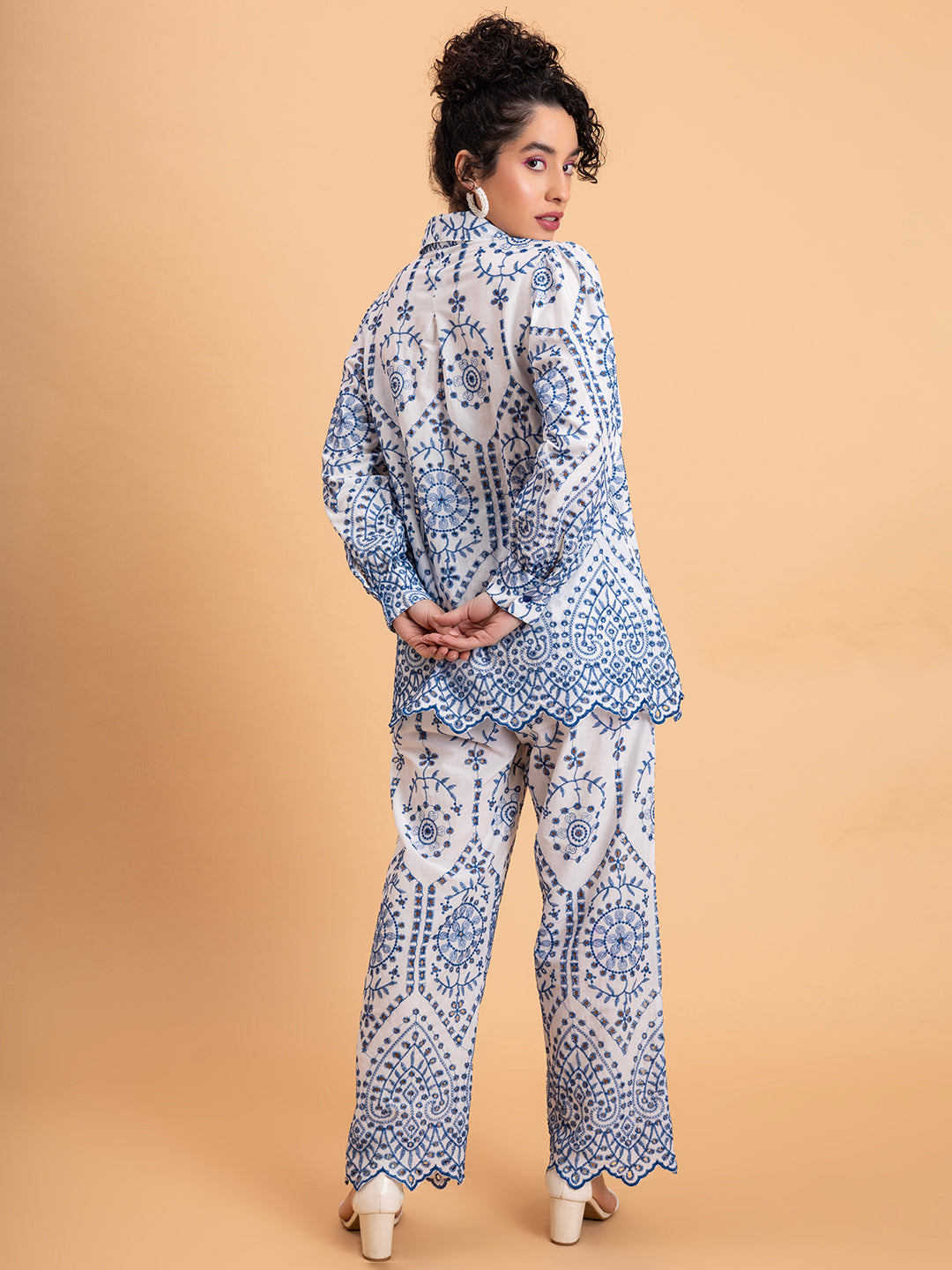 Close-up of intricate blue schiffli embroidery on white cotton co-ord
