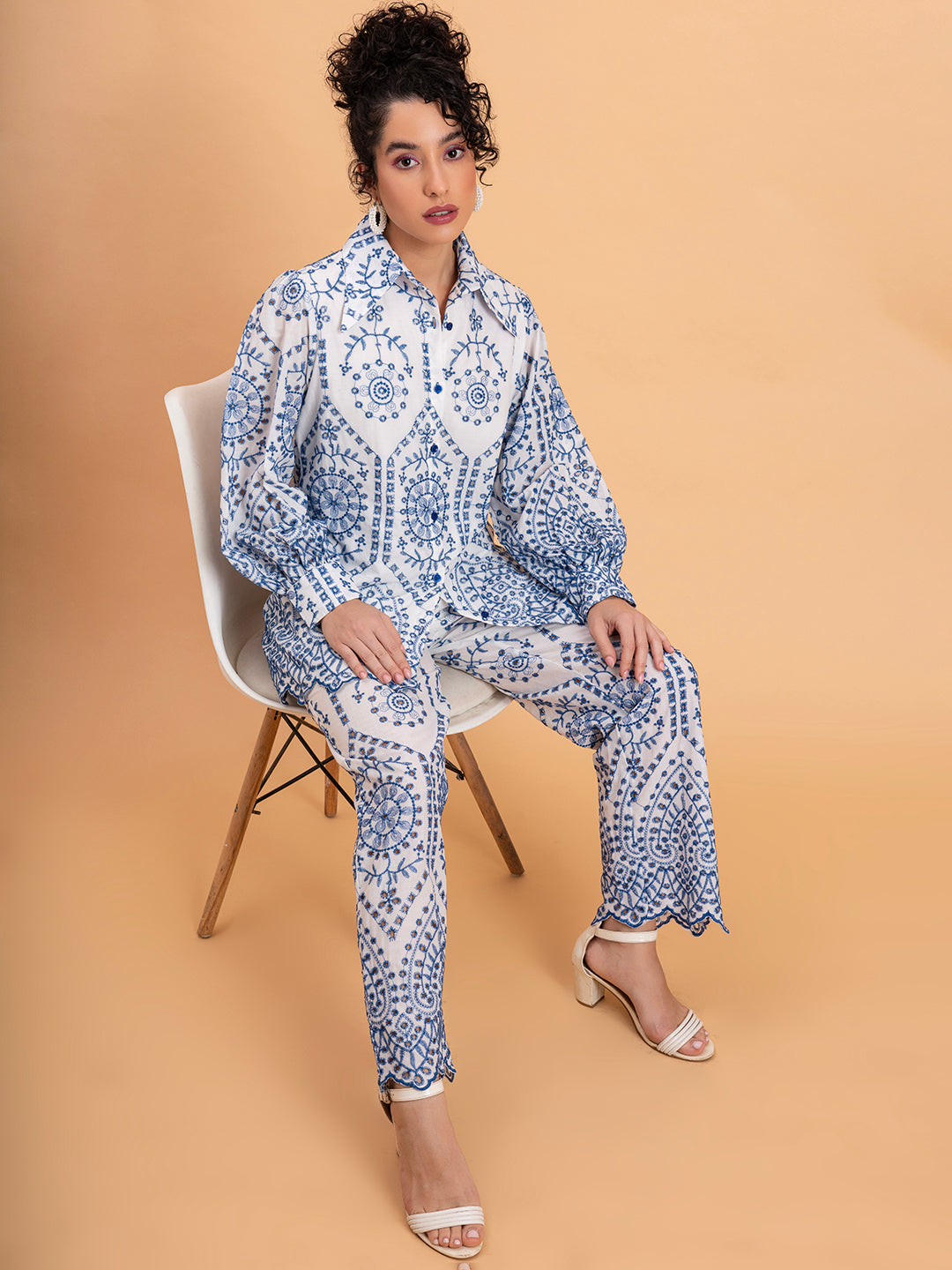 Lifestyle shot of woman wearing white embroidered shorts co-ord set