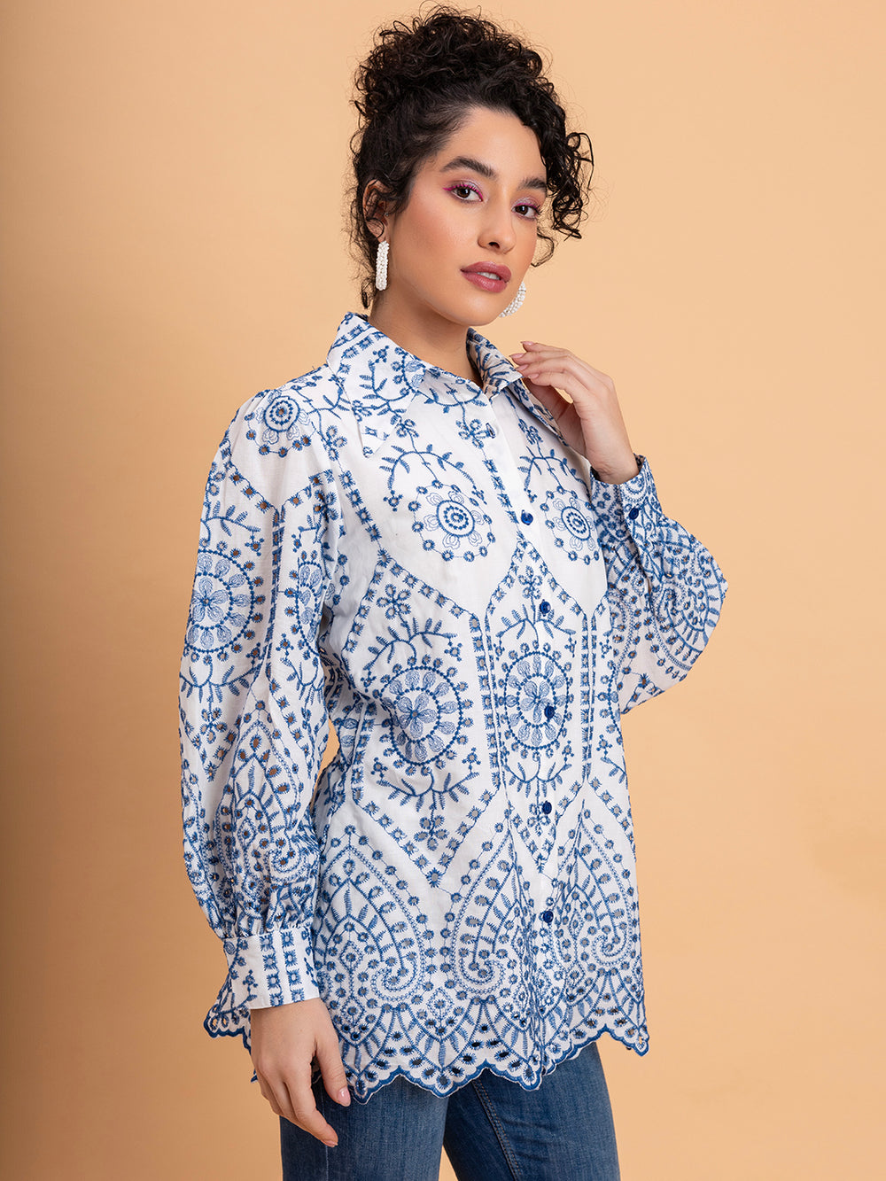 Side view of white cotton shirt highlighting blue schiffli embroidery detail