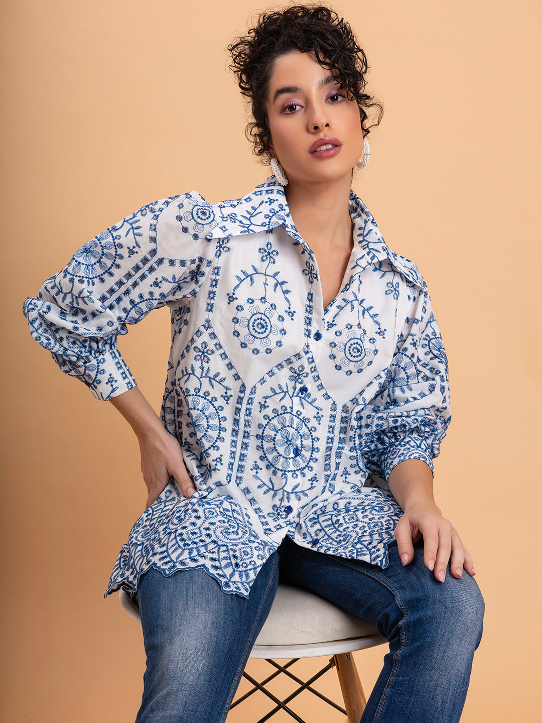 Lifestyle shot of white schiffli embroidered cotton shirt styled with denim