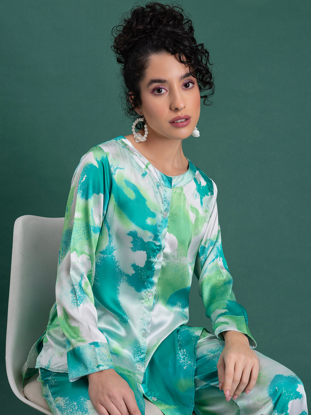 Lifestyle shot of green satin kurta co-ord with juttis