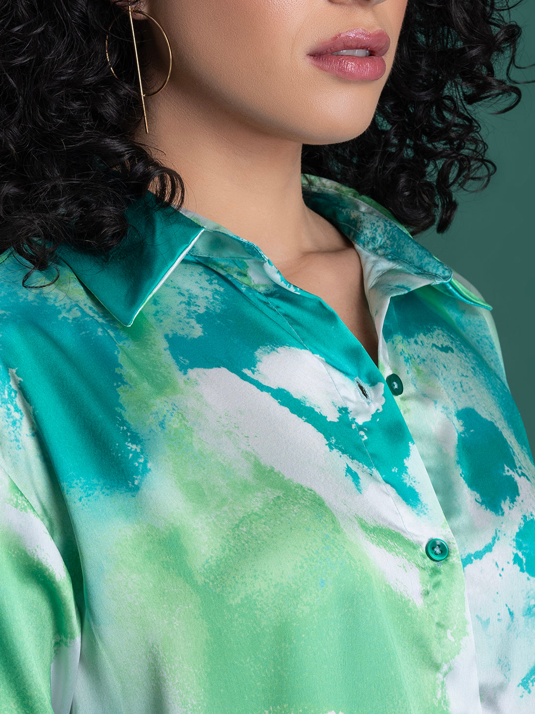 Spread collar and button placket on green satin shirt