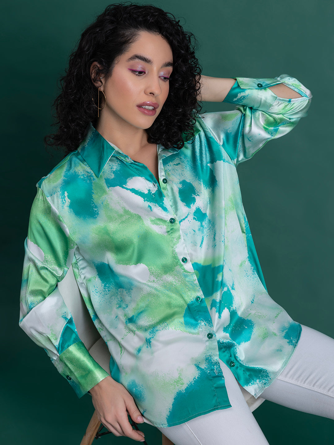 Lifestyle shot of green floral satin shirt styled with denim