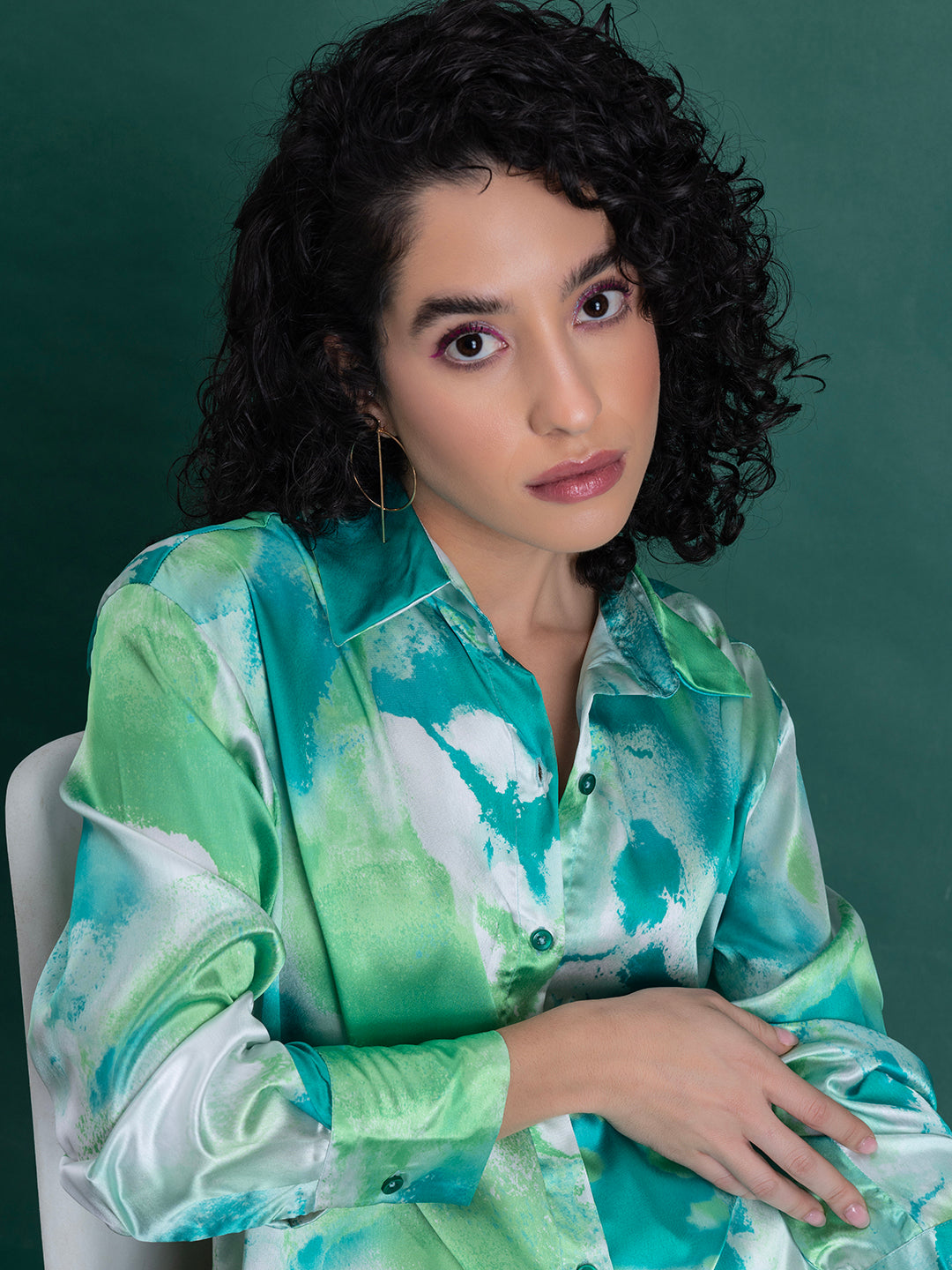 Curved hemline on green printed satin relaxed-fit shirt