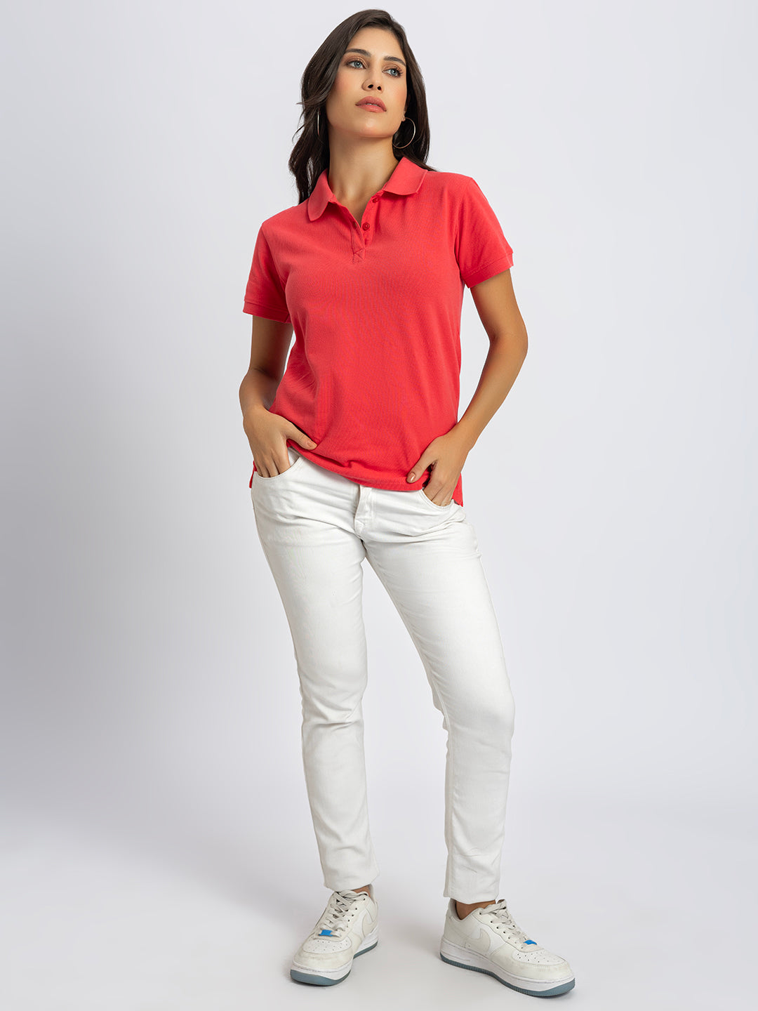 Lifestyle shot of woman wearing pink polo