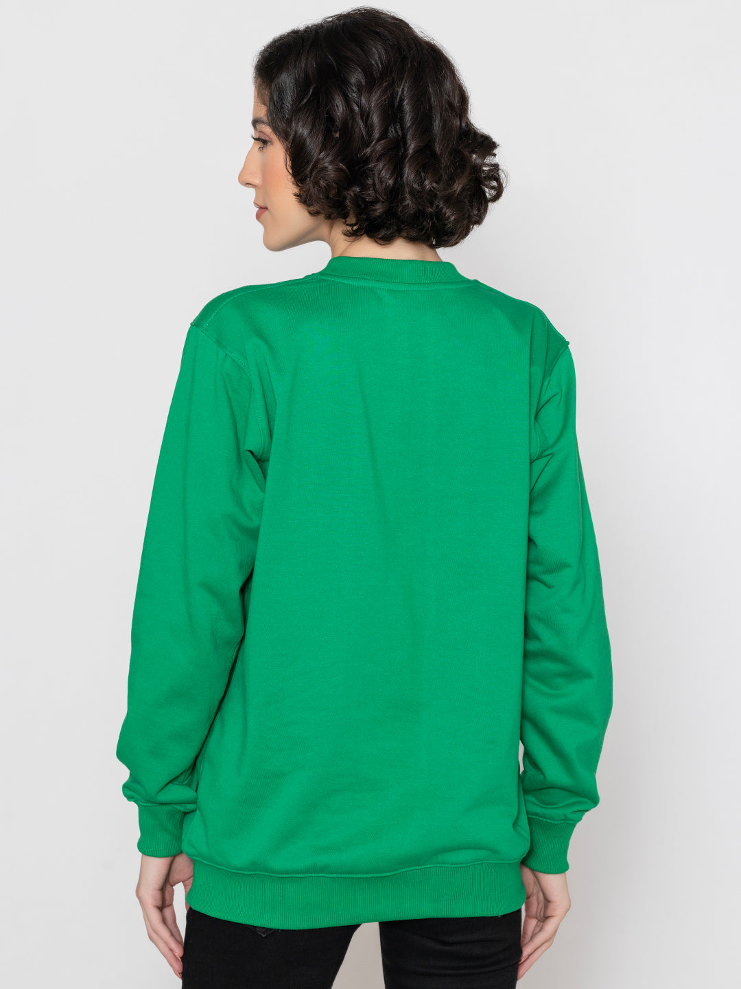 Lifestyle shot of green sweatshirt styled with joggers
