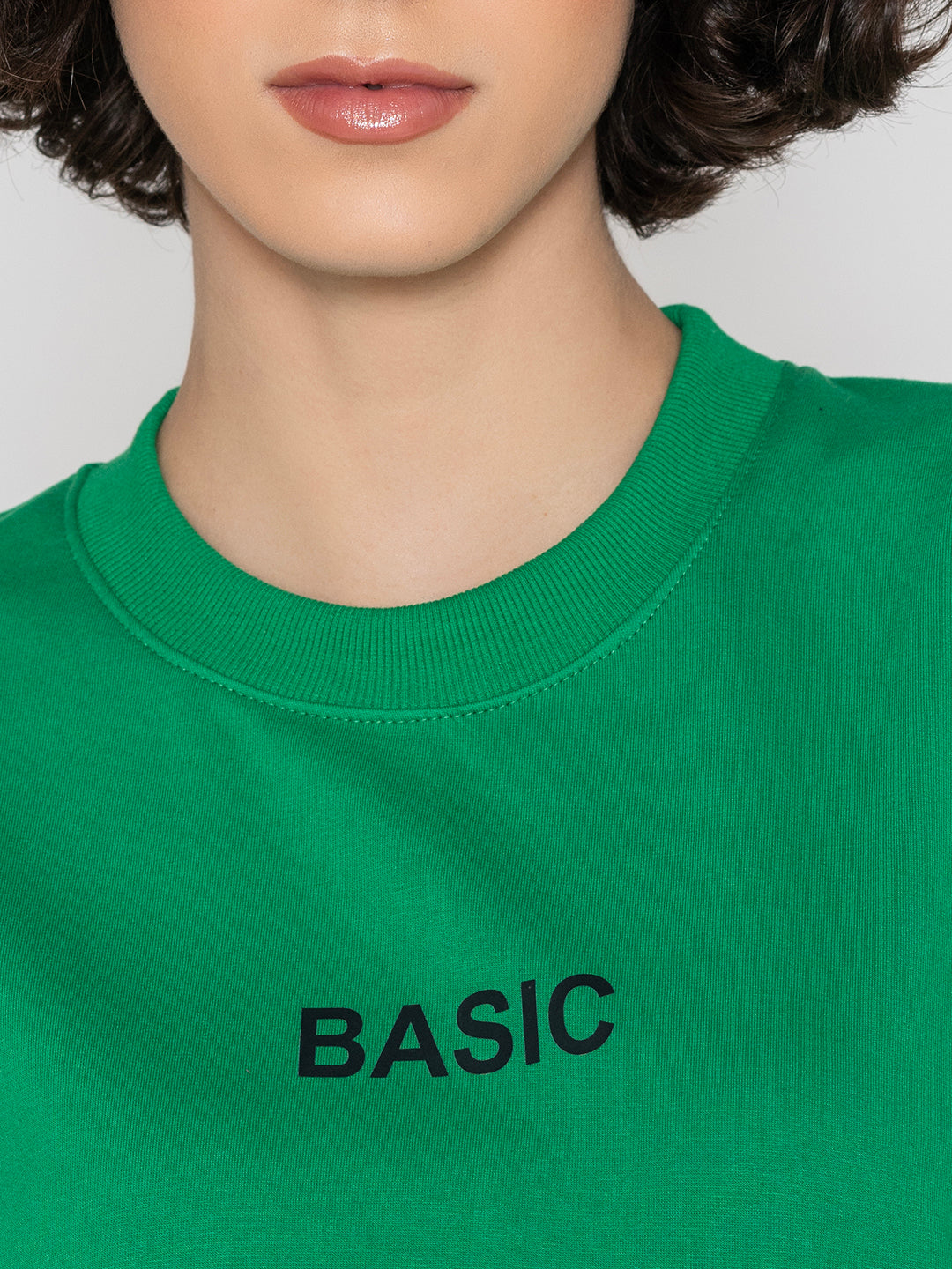 Detail of crew neck on green cotton blend sweatshirt