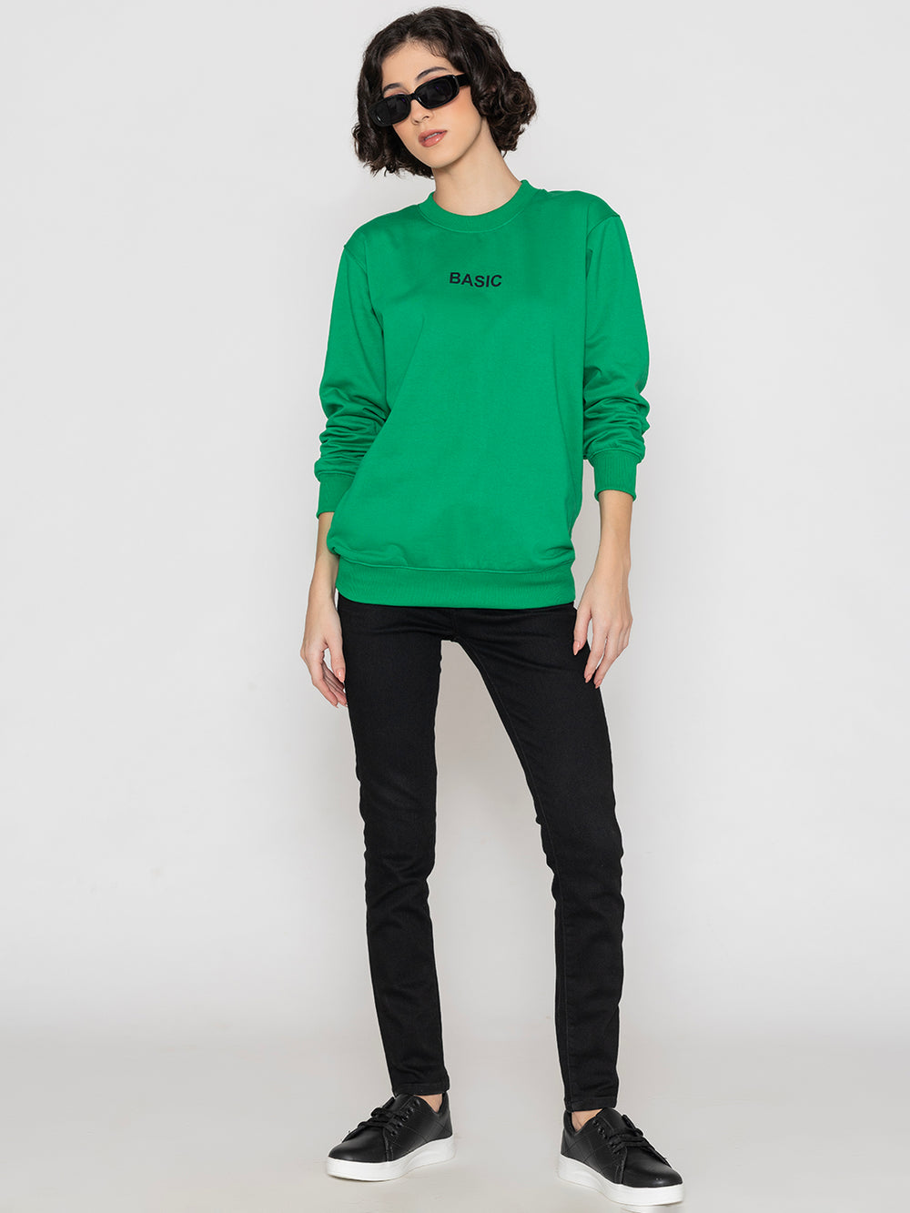 Side view of green sweatshirt showing relaxed drop-shoulder fit