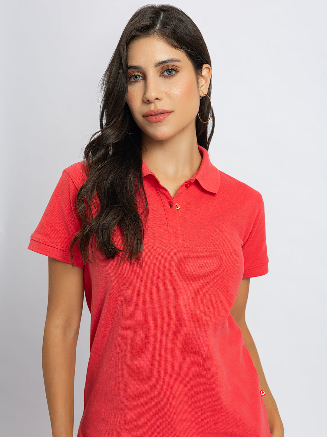 Detail of long sleeve cuff on pink cotton polo