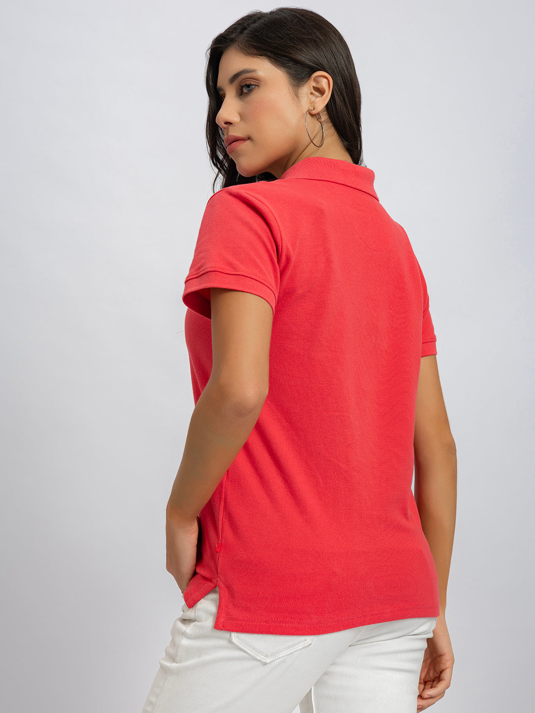 Styling shot of pink polo with denim
