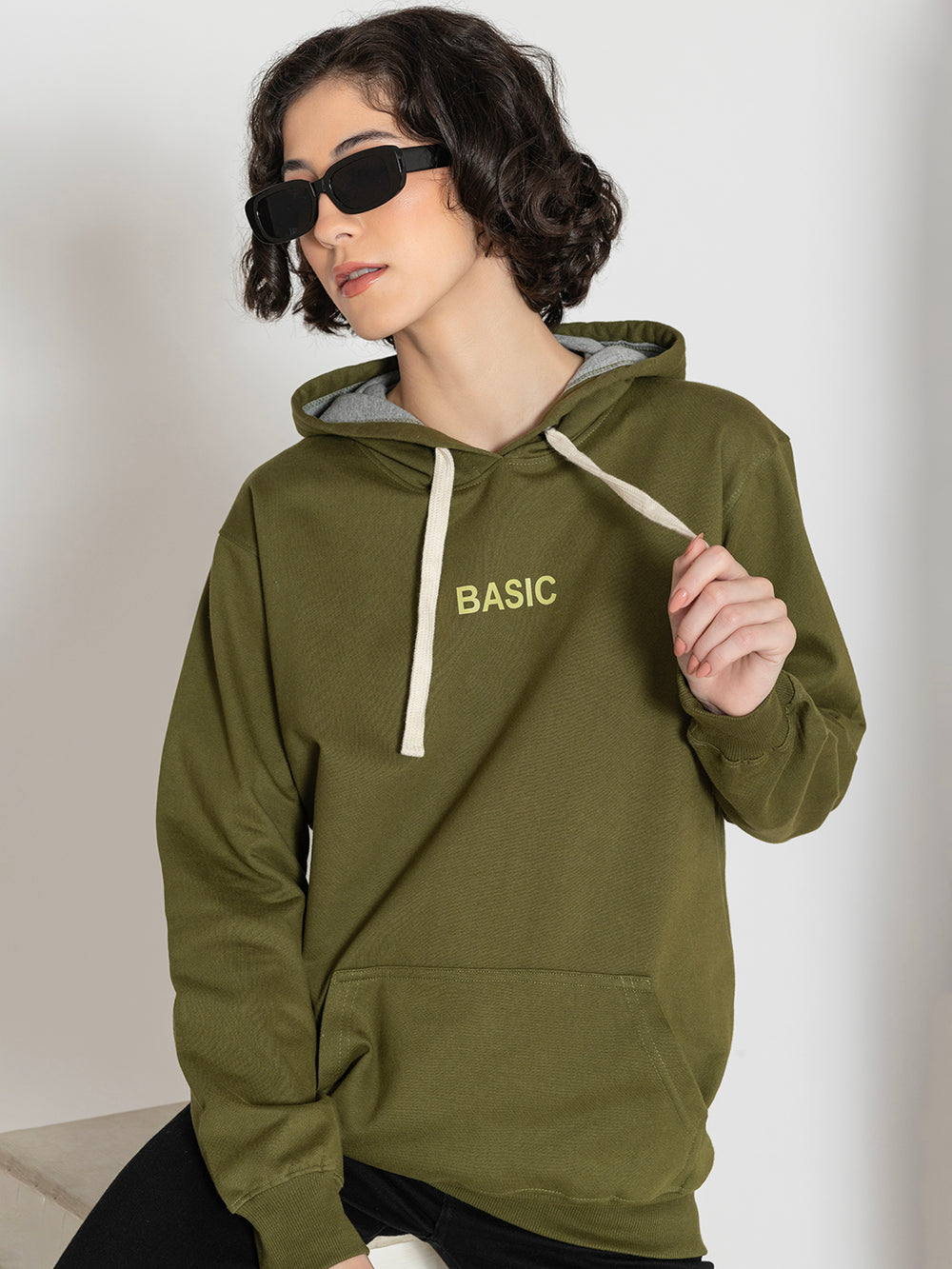 Side view of olive fleece hoodie showing relaxed silhouette