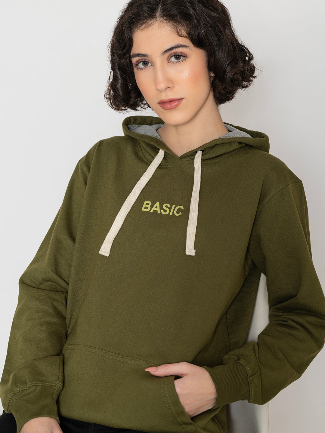 Lifestyle shot of olive hoodie styled with joggers