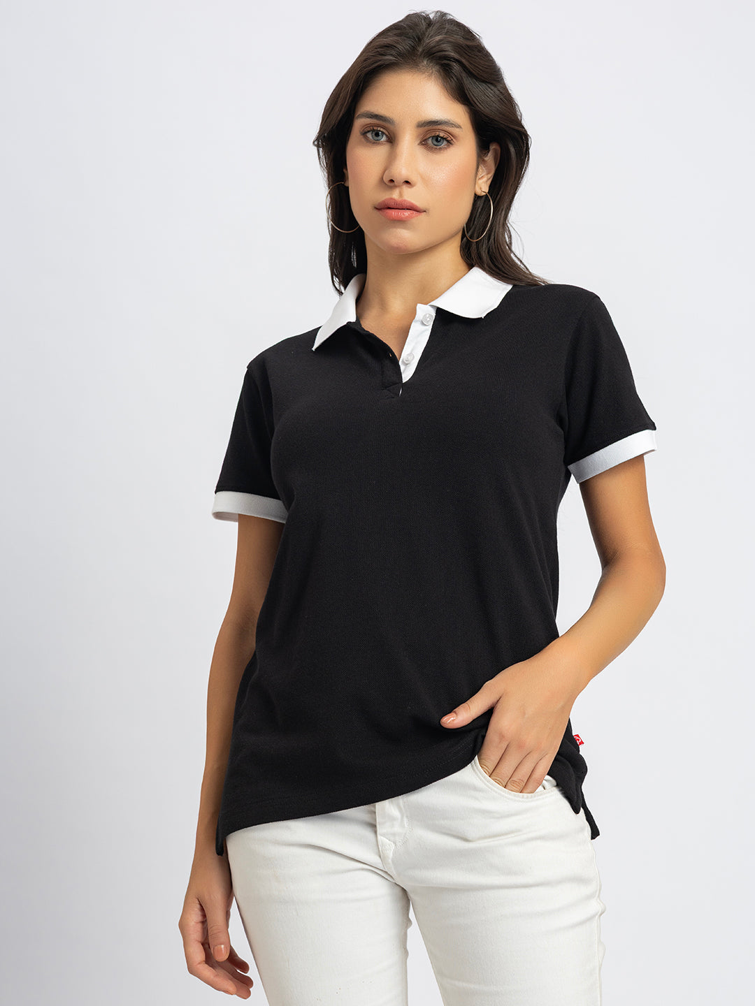 Lifestyle shot of woman wearing black and white collar polo