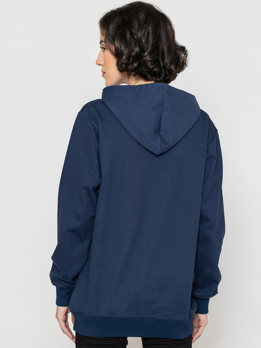 Navy hoodie shown in soft daylight