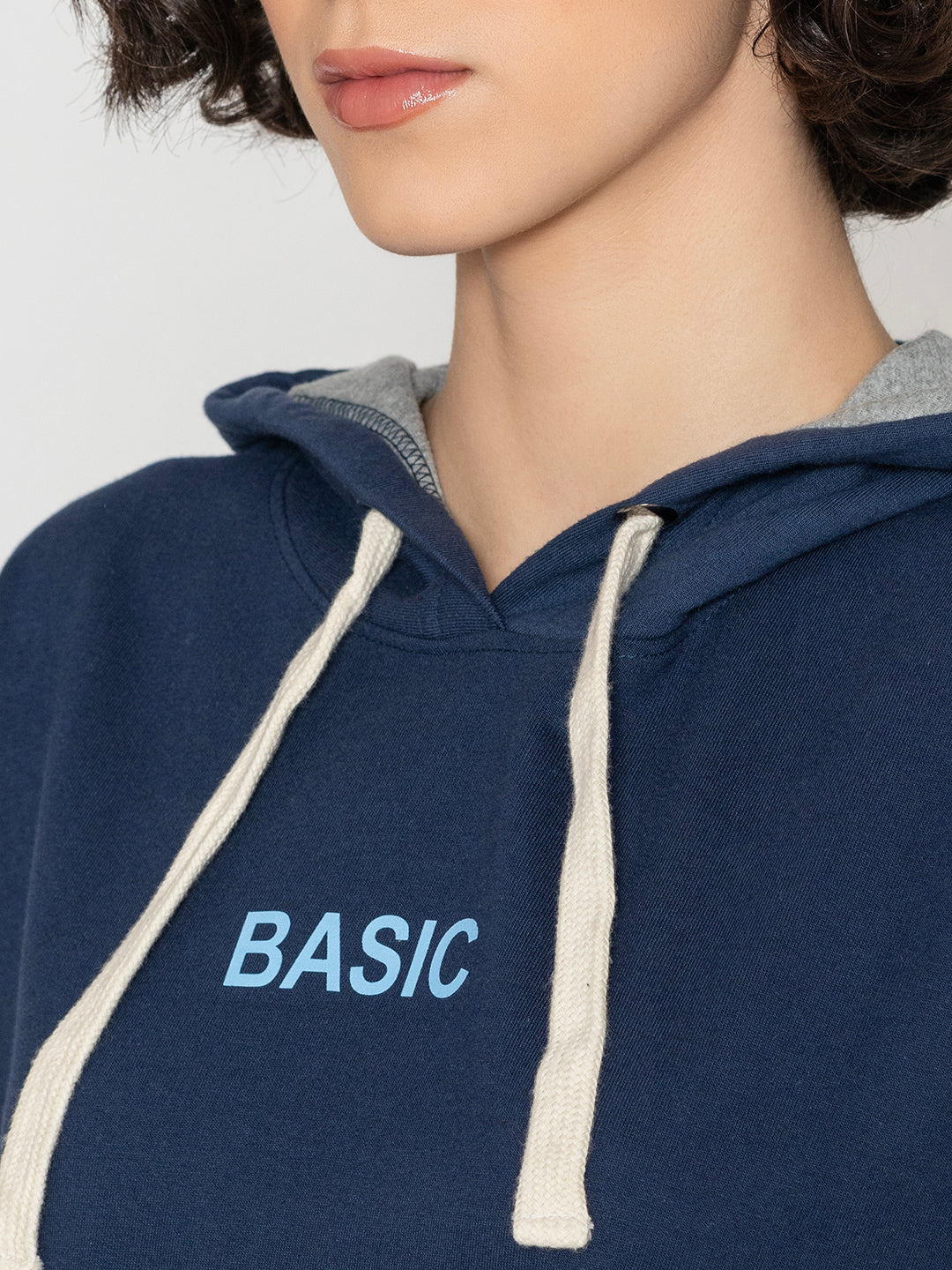 Lifestyle shot of navy hoodie styled with jeans
